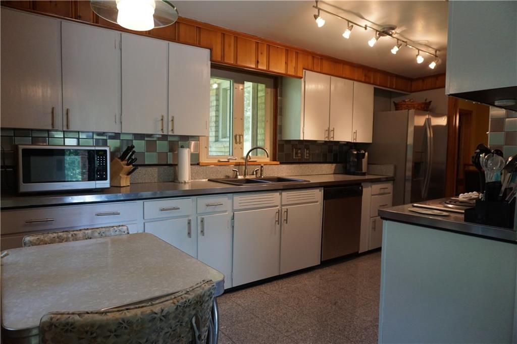 128 Teakwood Road Butler, PA 16001 - Photo 5 of 23 LIGHT AND BRIGHT EAT IN KITHEN WITH STAINLESS ACCENTS AND APPLIANCES