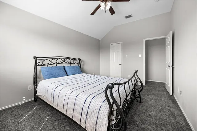 a bedroom with a bed and a television