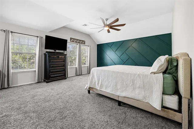 an empty room with a ceiling fan and a window