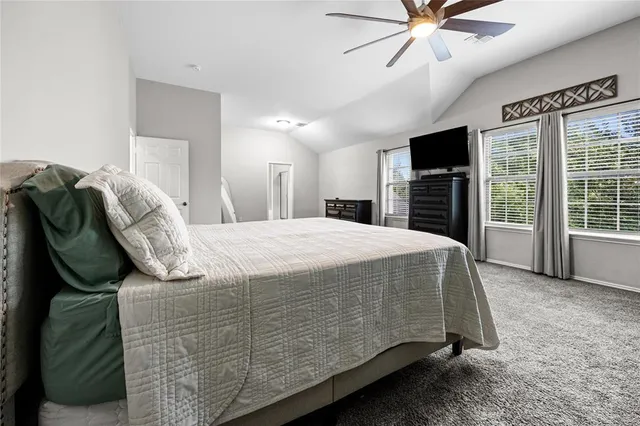 an empty room with a ceiling fan and window