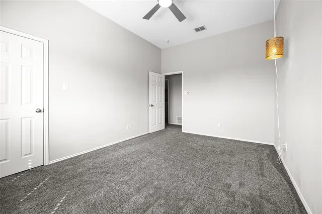 a kitchen with stainless steel appliances kitchen island granite countertop a refrigerator a stove a oven with white cabinets and wooden floor