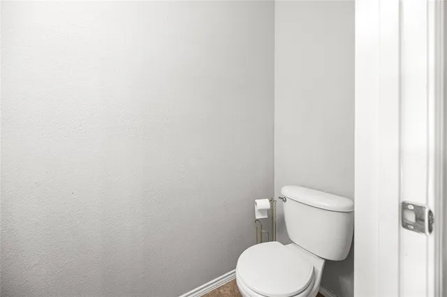 a view of empty room with wooden floor and stairs