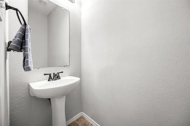 a bathroom with a sink and mirror