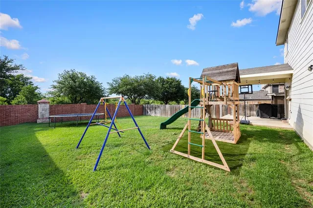 a view of a house with backyard and sitting area