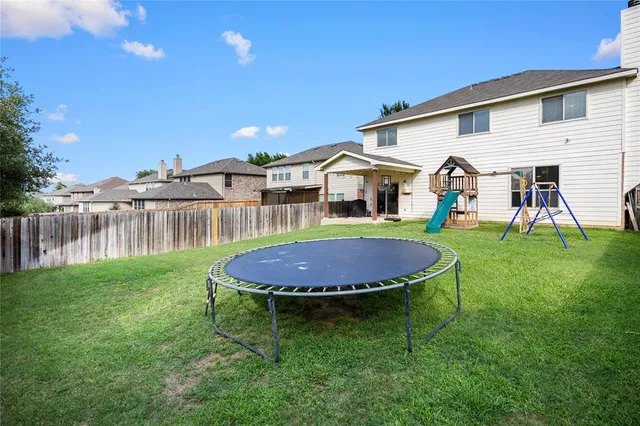 a view of a house with a yard and sitting area