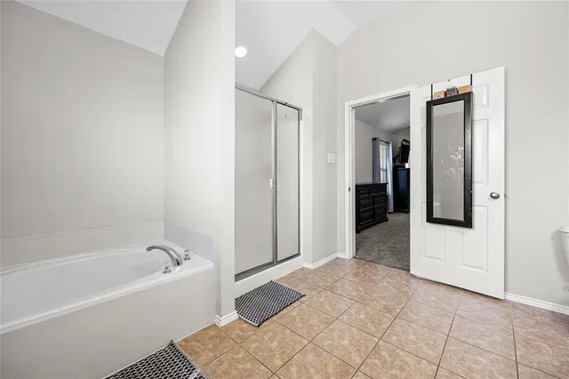 a spacious bathroom with a toilet sink and mirror