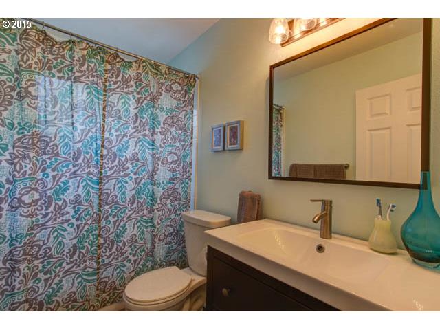 839 Southwest Broadway Drive, Unit 71 Portland, OR 97201 - Photo 12 of 15 a bathroom with a sink a toilet and mirror