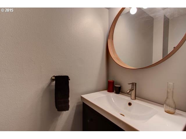 839 Southwest Broadway Drive, Unit 71 Portland, OR 97201 - Photo 13 of 15 a bathroom with a sink mirror and vanity