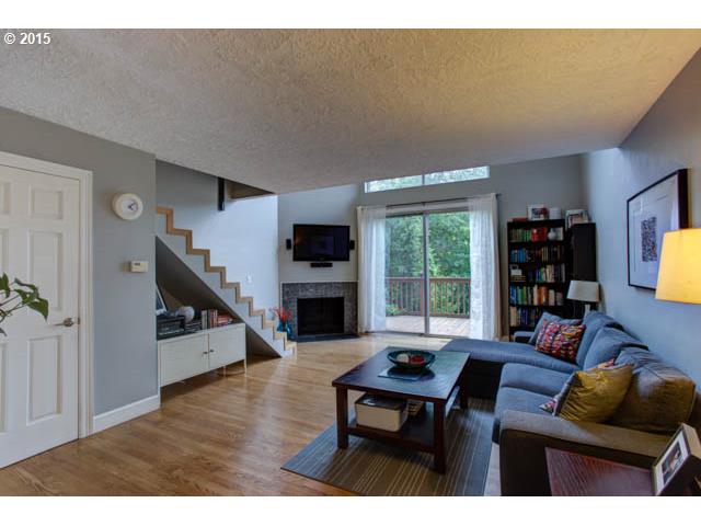 839 Southwest Broadway Drive, Unit 71 Portland, OR 97201 - Photo 2 of 15 a living room with furniture and a flat screen tv