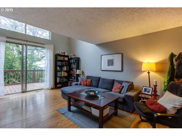 839 Southwest Broadway Drive, Unit 71 Portland, OR 97201 - Photo 3 of 15 a living room with furniture a lamp and a large window