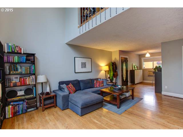 839 Southwest Broadway Drive, Unit 71 Portland, OR 97201 - Photo 5 of 15 a living room with furniture and a book shelf