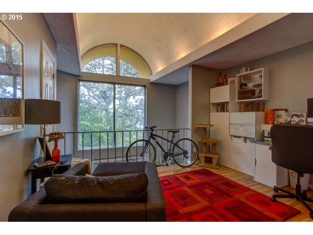 839 Southwest Broadway Drive, Unit 71 Portland, OR 97201 - Photo 8 of 15 a living room with furniture a flat screen tv and a large window