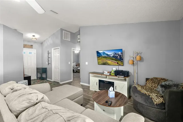 a living room with furniture and a chandelier