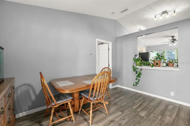a view of a dining room with furniture and wooden floor