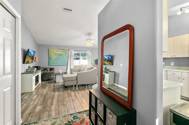 a living room with furniture and a floor to ceiling window