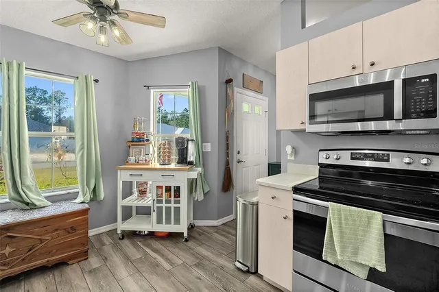 a kitchen with a stove a sink and a microwave