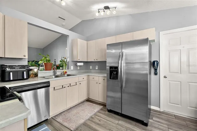 a kitchen with a refrigerator and a sink