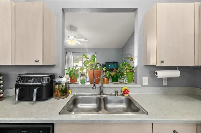 a kitchen with a sink and a stove top oven with wooden floor