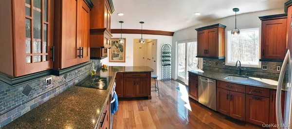 a large kitchen with a large window and stainless steel appliances