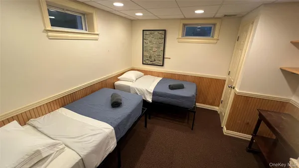 a picture of a room with a white wall and a white refrigerator