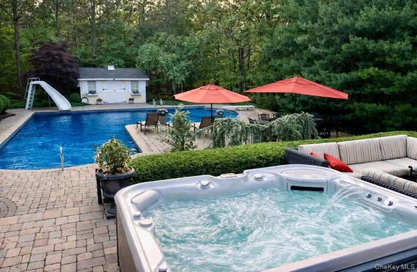 a view of a patio with a table and chairs under an umbrella