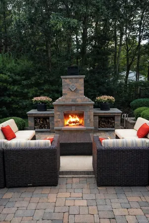 a view of a roof deck with couches fire pit and wooden fence