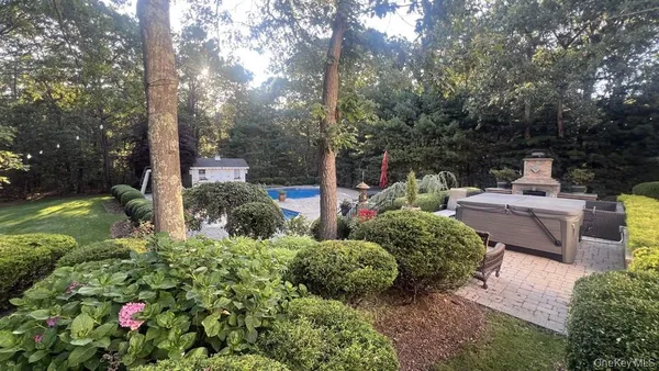 a view of a garden with flowers and trees