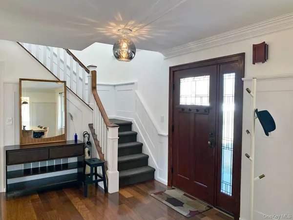 a view of entryway and hall with wooden floor