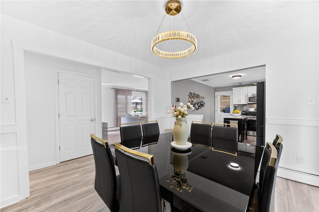 7290 Heather Road Macungie, PA 18062 - Photo 12 of 39 A radiant chandelier illuminates the formal dining space, complete with sleek black furnishings.