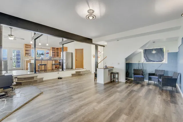 a kitchen with stainless steel appliances granite countertop a sink a stove and a wooden floors