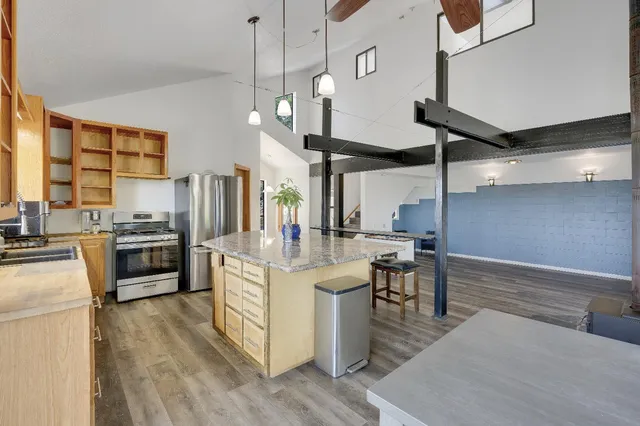 a view of staircase with lots of frames on wall and a window