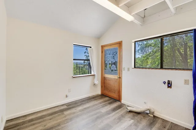 a view of a room with wooden floor and white doors