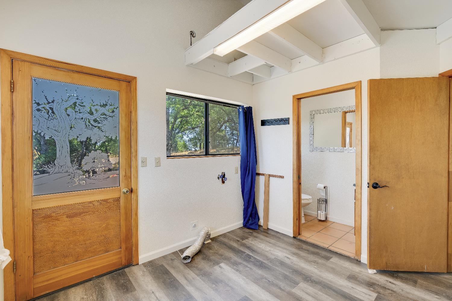 2261 Sand Ridge Road El Dorado, CA 95623 - Photo 20 of 61 a view of a bedroom with wooden floor and a window