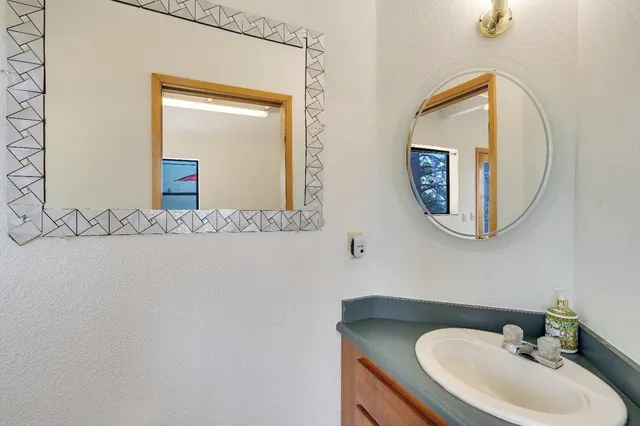 a bathroom with a sink mirror vanity and toilet