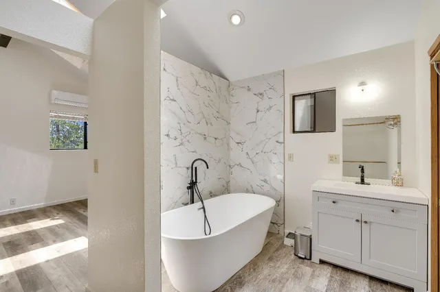 a view of a kitchen with fridge and wooden floor