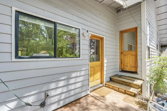 a view of a workspace with furniture and a window
