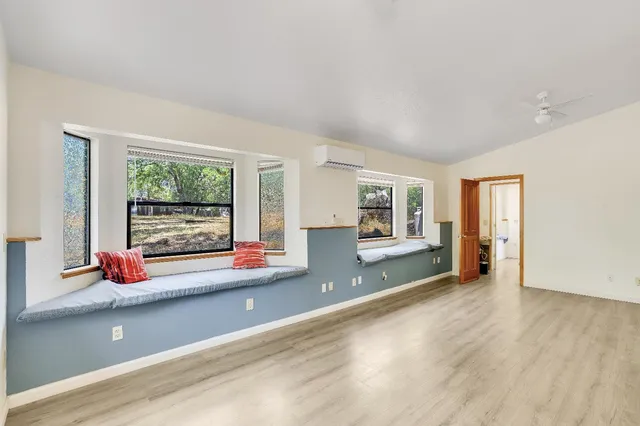 a view of an entryway with wooden floor and windows