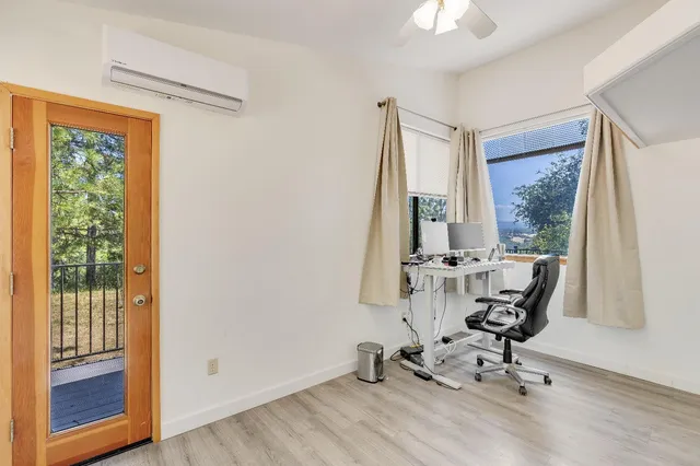 a front view of a house with a yard and seating space