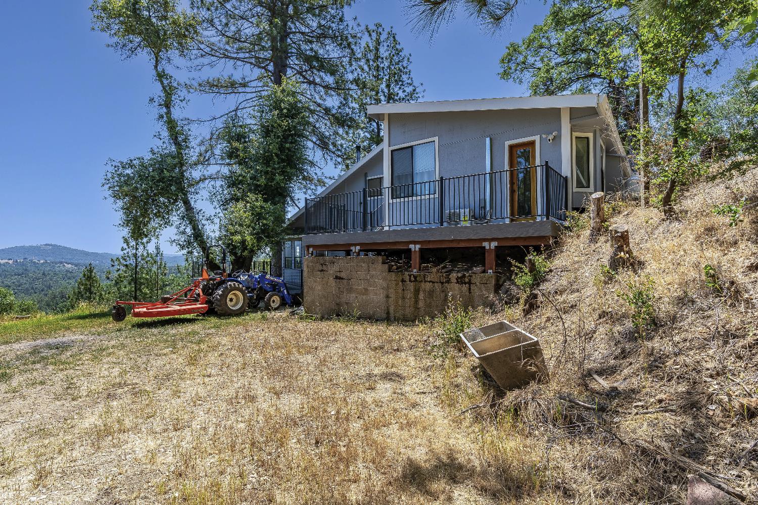 2261 Sand Ridge Road El Dorado, CA 95623 - Photo 38 of 61 a view of house with outdoor seating area and trees