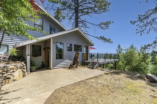 a backyard of a house with a tree