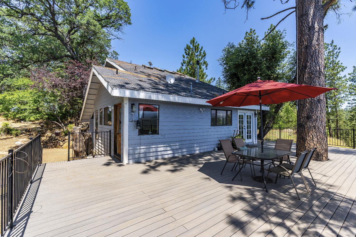 2261 Sand Ridge Road El Dorado, CA 95623 - Photo 46 of 61 a view of a patio with a table chairs and a barbeque