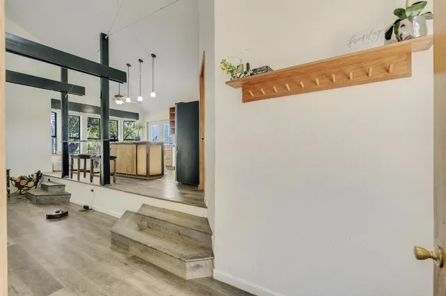 a view of an entryway with wooden floor