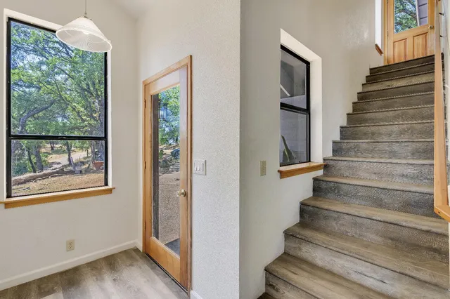 a view of entryway and hall with wooden floor