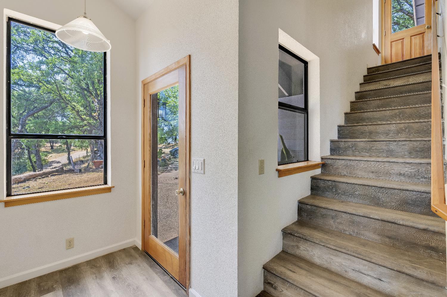 2261 Sand Ridge Road El Dorado, CA 95623 - Photo 6 of 61 a view of an entryway with wooden floor and windows