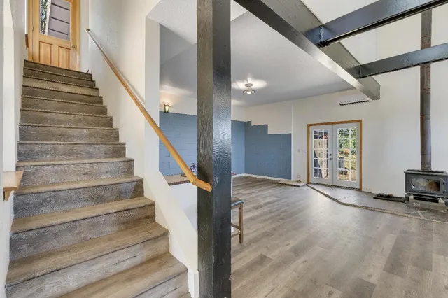 a living room with furniture and a dining table with wooden floor