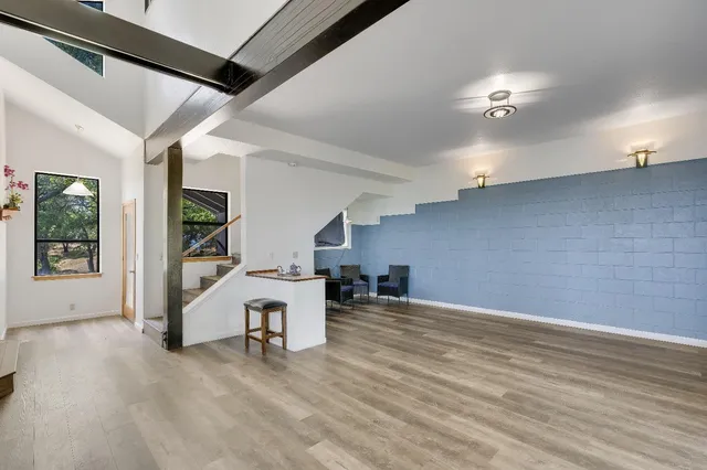 a kitchen with stainless steel appliances granite countertop a sink a stove and a refrigerator