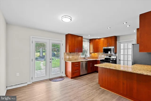 a large kitchen with lot of cabinets and stainless steel appliances