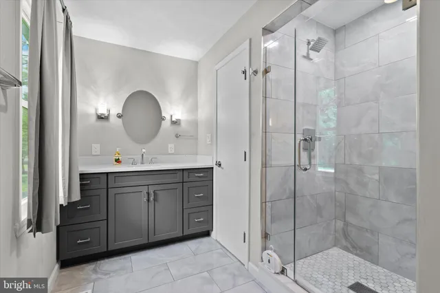 a bathroom with a double vanity sink mirror and shower