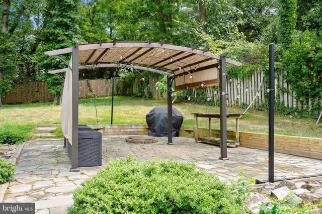 a view of a sitting area with some trees in the background