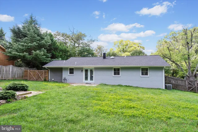 a view of a house with a yard and potted plants